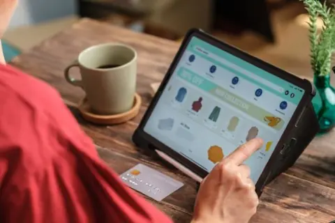 Online store owner checking orders on a tablet